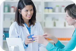 Dentist looking at supplies with coworker.