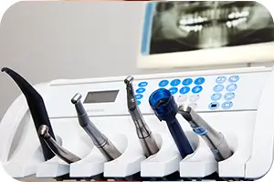 Set of dental tools and an x-ray of patient's teeth.